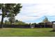 Community pool featuring a lush green lawn and mature trees at 761 Bourbon St # 5, Pahrump, NV 89048