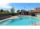 Community pool surrounded by lounge chairs and lush greenery at 761 Bourbon St # 5, Pahrump, NV 89048