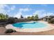 Community pool, clear blue water, surrounded by grass at 761 Bourbon St # 5, Pahrump, NV 89048