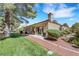 A beautifully landscaped backyard featuring a cozy patio, lush lawn, and mature trees offers serene outdoor living at 7909 Canoe Ln, Las Vegas, NV 89145