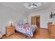 Main bedroom with hardwood floors and a wall-mounted TV at 7909 Canoe Ln, Las Vegas, NV 89145