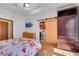 Bright bedroom with wooden floors, closet, and access to the bathroom with a barn door at 7909 Canoe Ln, Las Vegas, NV 89145