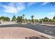 Community entrance featuring palm trees and wrought iron gates gives a sense of security and exclusivity at 7909 Canoe Ln, Las Vegas, NV 89145