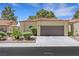 Charming home featuring a two-car garage, mature landscaping, and tile roof at 7909 Canoe Ln, Las Vegas, NV 89145