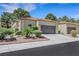 Charming single-story home with a two-car garage, beautiful landscaping, and a tile roof at 7909 Canoe Ln, Las Vegas, NV 89145