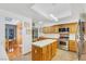 Bright kitchen with stainless steel appliances, a central island, and wood cabinets at 7909 Canoe Ln, Las Vegas, NV 89145