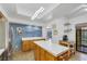 Bright kitchen with stainless steel refrigerator and a modern light fixture at 7909 Canoe Ln, Las Vegas, NV 89145