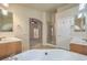Bright bathroom featuring a tub, shower, double sinks, and neutral tile flooring at 7998 Base Camp Ave, Las Vegas, NV 89178