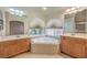 Bright bathroom with a tub, double sinks, tile flooring, and natural lighting at 7998 Base Camp Ave, Las Vegas, NV 89178