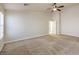 Spacious bedroom featuring carpet, ceiling fan, base trim, and natural light at 7998 Base Camp Ave, Las Vegas, NV 89178