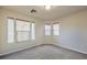 Bedroom featuring carpet flooring, base trim, three windows, and neutral walls at 7998 Base Camp Ave, Las Vegas, NV 89178