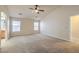 Bright primary bedroom with large windows, ceiling fan, and carpeted floors at 7998 Base Camp Ave, Las Vegas, NV 89178