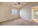 Bedroom with a carpet floor, window, ceiling fan, base trim, and neutral walls at 7998 Base Camp Ave, Las Vegas, NV 89178