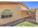 Exterior view of patio with brick floor, green grass, and large arched windows at 7998 Base Camp Ave, Las Vegas, NV 89178