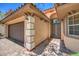 Stunning front entry featuring a two-car garage, stylish pillars and an arched walkway to the double door entryway at 7998 Base Camp Ave, Las Vegas, NV 89178