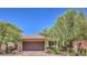 Charming single-story home featuring a terra cotta roof, desert landscaping, and a two-car garage at 7998 Base Camp Ave, Las Vegas, NV 89178