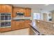 Kitchen featuring wooden cabinets, stainless steel appliances and granite countertops at 7998 Base Camp Ave, Las Vegas, NV 89178