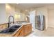 Bright kitchen with granite countertops and a stainless steel refrigerator at 7998 Base Camp Ave, Las Vegas, NV 89178