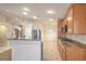 Well-lit kitchen with a stainless steel refrigerator and granite countertops at 7998 Base Camp Ave, Las Vegas, NV 89178