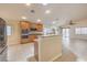 Open concept kitchen with granite countertops and a stainless steel refrigerator at 7998 Base Camp Ave, Las Vegas, NV 89178