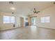 Spacious living room featuring neutral tile floors, fireplace, and a ceiling fan, perfect for entertaining or relaxing at 7998 Base Camp Ave, Las Vegas, NV 89178