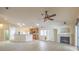 Open-concept living room and kitchen with breakfast bar, fireplace, and sliding glass doors for indoor-outdoor living at 7998 Base Camp Ave, Las Vegas, NV 89178