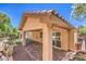 The covered patio features brick floors, a stucco ceiling, and outside foliage at 7998 Base Camp Ave, Las Vegas, NV 89178