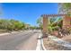 Paved community street with mature trees and view of community buildings at 7998 Base Camp Ave, Las Vegas, NV 89178