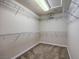 Spacious walk-in closet with carpet and multiple levels of shelving and storage at 7998 Base Camp Ave, Las Vegas, NV 89178