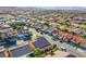 Expansive aerial view of a neighborhood with neatly arranged homes, streets, and mountain backdrop at 8026 Sunset Creek St, Las Vegas, NV 89113