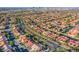 Extensive aerial view of a large suburban area with uniform houses, tree-lined streets, and city skyline at 8026 Sunset Creek St, Las Vegas, NV 89113