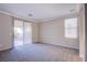 Carpeted bedroom with sliding glass doors and a large window for ample lighting at 8026 Sunset Creek St, Las Vegas, NV 89113
