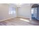 Bright dining room featuring wood floors, large window, and a modern chandelier at 8026 Sunset Creek St, Las Vegas, NV 89113