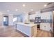Bright and airy kitchen featuring an island with seating, stainless steel appliances, and tiled backsplash at 8026 Sunset Creek St, Las Vegas, NV 89113