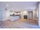 Open concept living room featuring a fireplace and flowing into the kitchen at 8026 Sunset Creek St, Las Vegas, NV 89113