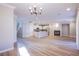 Open-concept living space seamlessly connecting kitchen, dining, and living areas with a fireplace at 8026 Sunset Creek St, Las Vegas, NV 89113