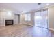 Spacious living room with a cozy fireplace and sliding glass doors leading to the outdoor space at 8026 Sunset Creek St, Las Vegas, NV 89113