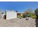 Partially xeriscaped backyard with storage shed and partial patio cover at 812 Bitterroot St, Henderson, NV 89002