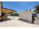 Backyard featuring a covered patio, storage shed, and open-air concrete pad at 812 Bitterroot St, Henderson, NV 89002