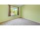 Bright bedroom featuring a window with curtains, carpeted floors, and soft green walls for a relaxing feel at 812 Bitterroot St, Henderson, NV 89002