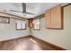Bright bonus room with wood-look floors, two windows, and a ceiling fan, perfect for a home office at 812 Bitterroot St, Henderson, NV 89002