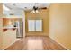 Bright dining area with wood floors, a ceiling fan, and a view of the stainless steel refrigerator at 812 Bitterroot St, Henderson, NV 89002