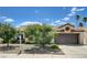 Charming single-story home featuring desert landscaping, a two-car garage, and mature trees in a residential neighborhood at 812 Bitterroot St, Henderson, NV 89002