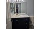 Modern bathroom with a vanity, dark cabinets, mirror, and neutral countertop at 8455 W Sahara Ave # 258, Las Vegas, NV 89117
