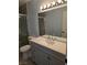 Updated bathroom features a modern vanity, large mirror and tiled walk-in shower at 8455 W Sahara Ave # 258, Las Vegas, NV 89117