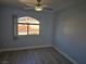 Bright bedroom with wood-look floors, ceiling fan, and a window offering natural light at 8455 W Sahara Ave # 258, Las Vegas, NV 89117