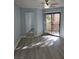 Sunlit bedroom with sliding glass door access to a balcony, mirror and light wood floors at 8455 W Sahara Ave # 258, Las Vegas, NV 89117