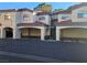 Multi-level condo building with terracotta tile roof, covered parking, and landscaped entrance at 8455 W Sahara Ave # 258, Las Vegas, NV 89117