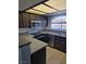 Well-lit kitchen with stainless steel appliances, modern countertops, and dark cabinetry at 8455 W Sahara Ave # 258, Las Vegas, NV 89117
