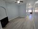 Spacious living room with wood-look flooring, fireplace, ceiling fan, and light blue walls at 8455 W Sahara Ave # 258, Las Vegas, NV 89117